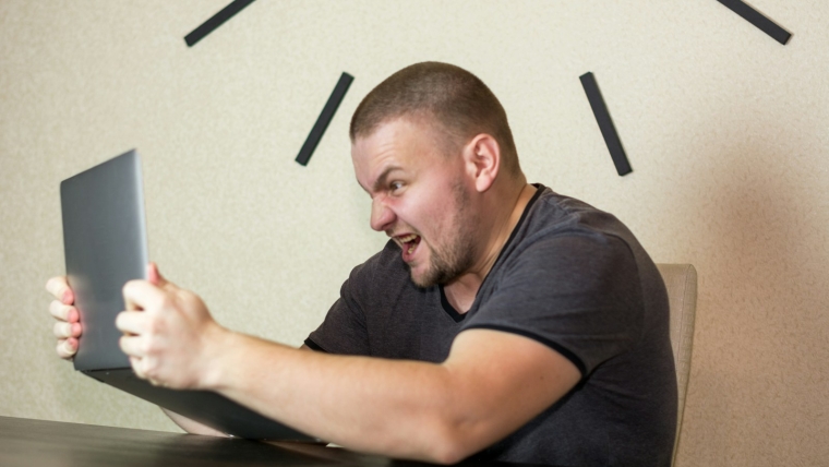 a man sitting in front of a laptop computer